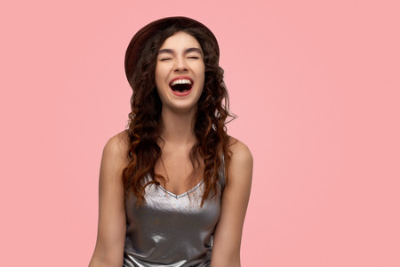 Excited  adult girl closing her eyes and opening mouth screaming with happiness rejoicing her success in life. Shining woman enjoying her life. Happiness and joy concept.の写真素材