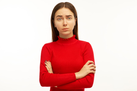 Handsome young student woman has serious look, listens interlocutor very attentively. Beautiful female puzzled looking at you and asks, "Friend, you really did it? That can't be true."の写真素材