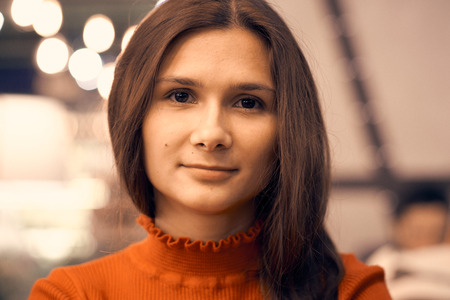 A picture of a beautiful girl with dark long hair and burning brown eyes. A young woman looks at the camera.の写真素材