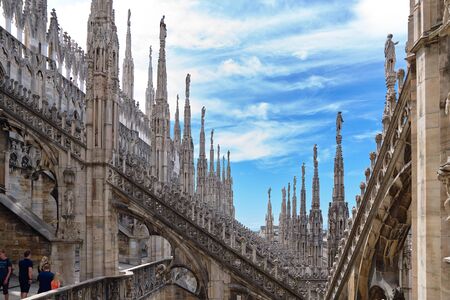 View over amazing cathedral Duomo di Milano, famous city landmark and the largest gothic church in Italy. Gorgeous gothic facade with rich ornate stone decoration.の写真素材