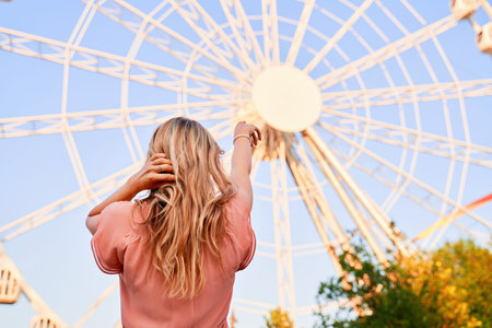 Back of girl shows her finger on wheel of review
