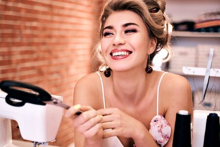 Blonde girl seamstress with creative hairdo Studioの写真素材