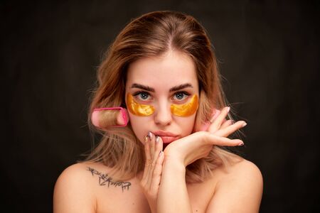Closeup girl touches face hands looks thoughtfullyの写真素材