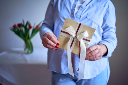 medium-sized woman holds a craft gift certificate in her hands