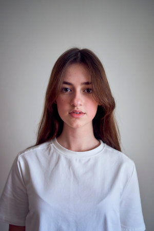a portrait of a beautiful teenage girl on a chair in a bright room in a minimalist style