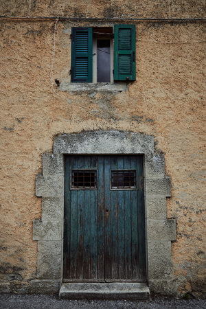 blue old door and window in mediterranean style on stone wallの写真素材