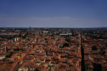 a top view of the terracotta roofs of Bologna, the atmosphere of the Italian summer