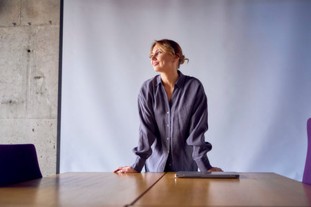 a  beautiful business woman speaking at a meeting in front of a large projector screen