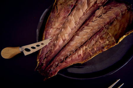 process of dissecting hot smoked golden horse mackerel with small knivesの写真素材