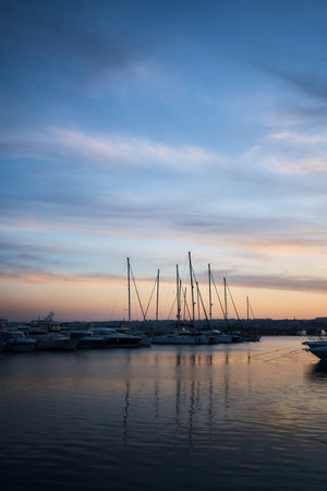 the boats, sailboats in the harbor at sunsetの写真素材
