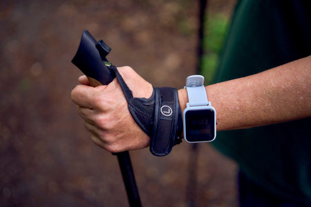 an old woman uses a fitness bracelet