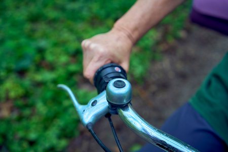 an elderly woman walking in spring forest with bicycle and yoga matの写真素材