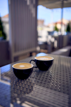 cups of coffee, latte and cappuccino on a table in a cafeの写真素材