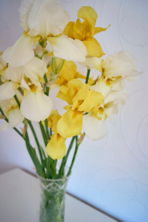 bouquet of yellow and white irises in a crystal vase in the interior