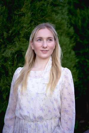 a portrait of a young blonde woman in a pastel chiffon dressの写真素材