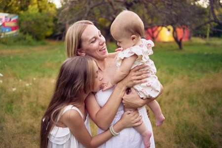 a mother playing with her daughters
