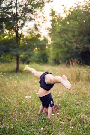 10-year-old gymnast practices in the garden