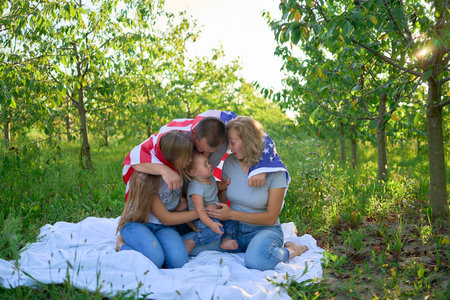 a  family on independence day picnic with american flag