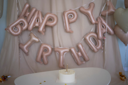 baby girl tries her first birthday cake with mom and pre-teen sister