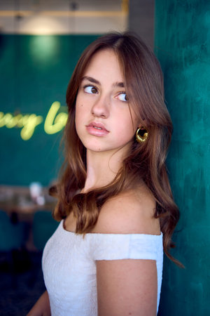 16-year-old teenage girl in old money style clothes in  fancy restaurant
