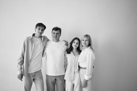 family, middle-aged husband and wife, young adult son and teenage daughter, on a white background,...