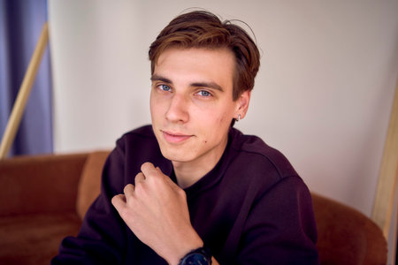 a  portrait of an attractive young 20 year old man with dark hair and blue eyes, studio photo shoot