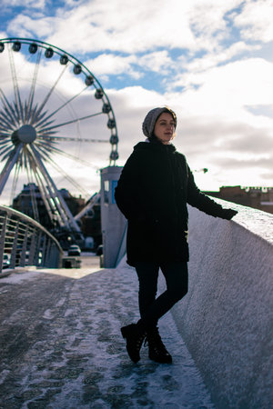 young woman in front of the Ferris wheel in GdaÅskの写真素材
