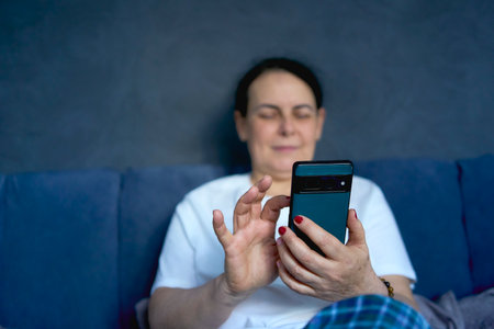 person using smartphone while relaxingの写真素材