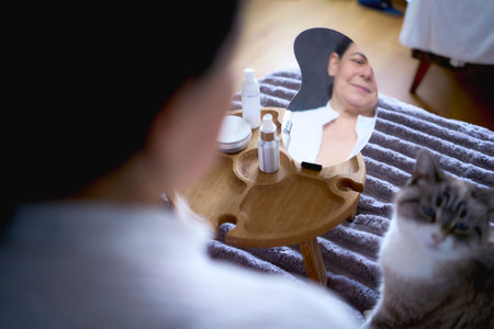 Person relaxing while performing skincare routine with cosmetic products