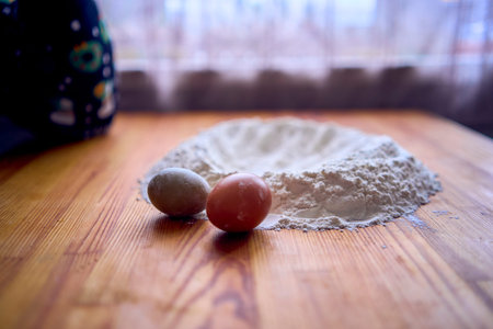 Baking ingredients with flour and eggs on a wooden table