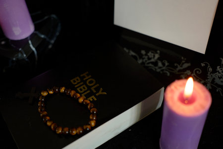 funeral, photo frame, candles, marble urn for ashes, holy bible and spiritual bracelet with black crossの写真素材