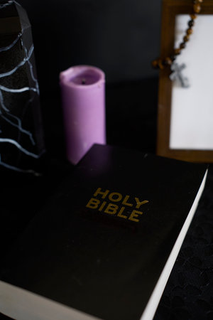 funeral, photo frame, candles, marble urn for ashes, holy bible and spiritual bracelet with black crossの写真素材