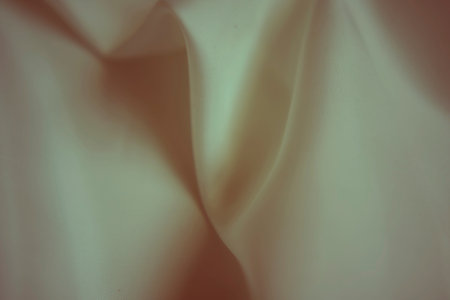 Elegant ivory white silk fabric with soft ripples and subtle greenish tint
