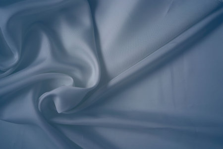 White and cashmere blue silk fabric with elegant flowing fold