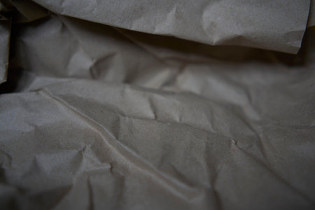 Crumpled brown kraft paper texture with rough folds