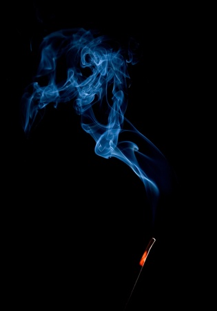 Smoke of incense stick isolated on the black backgroundの写真素材