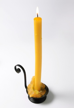 Candle with yellow malted wax isolated on white backgroundの写真素材