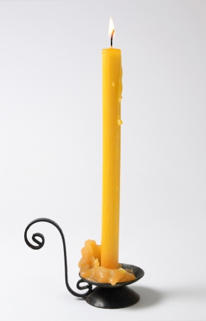 Candle with yellow malted wax isolated on white backgroundの写真素材