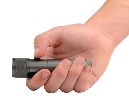 Hand holding a bright led flashlight の写真素材