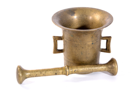 Brass mortar with a pestle isolated on a white backgroundの写真素材