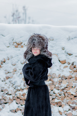 Girl in a fur hat winter dayの写真素材