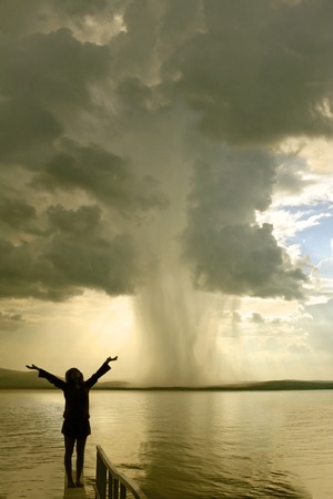 the begining of the tornado and girl silhouetteの写真素材