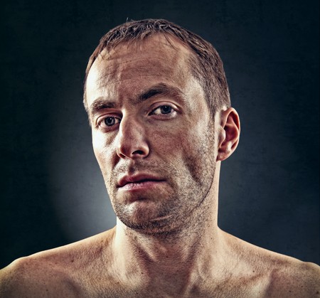 portrait of rough face  man over dark backgroundの写真素材