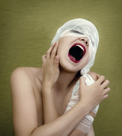 screaming young woman in bandageの写真素材