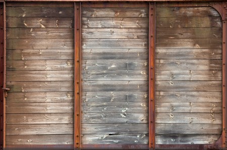 old wooden wall in rusty metal frame textureの写真素材