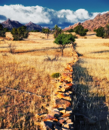 border wall pastures on dry land fields of Moroccoの写真素材