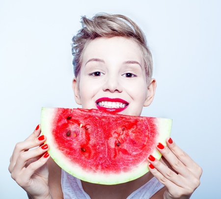 young beauty woman holding watermelon in her handの写真素材