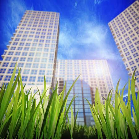 green grass and skyscrapers, aspiring to the sky in the backgroun  Shallow DOFの写真素材