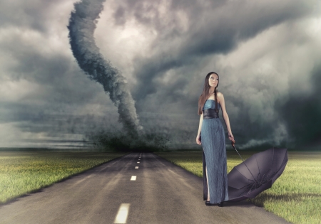 woman,with umbrella on the road and tornado  photo and hand-drawing elements compilation  の写真素材