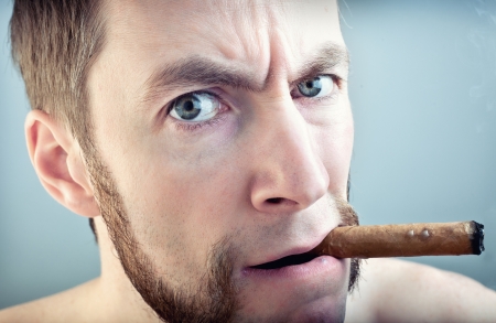 a man with a cigar, looking into the cameraの写真素材